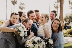 Bride, Groom, and Wedding Party giving each other a big hug